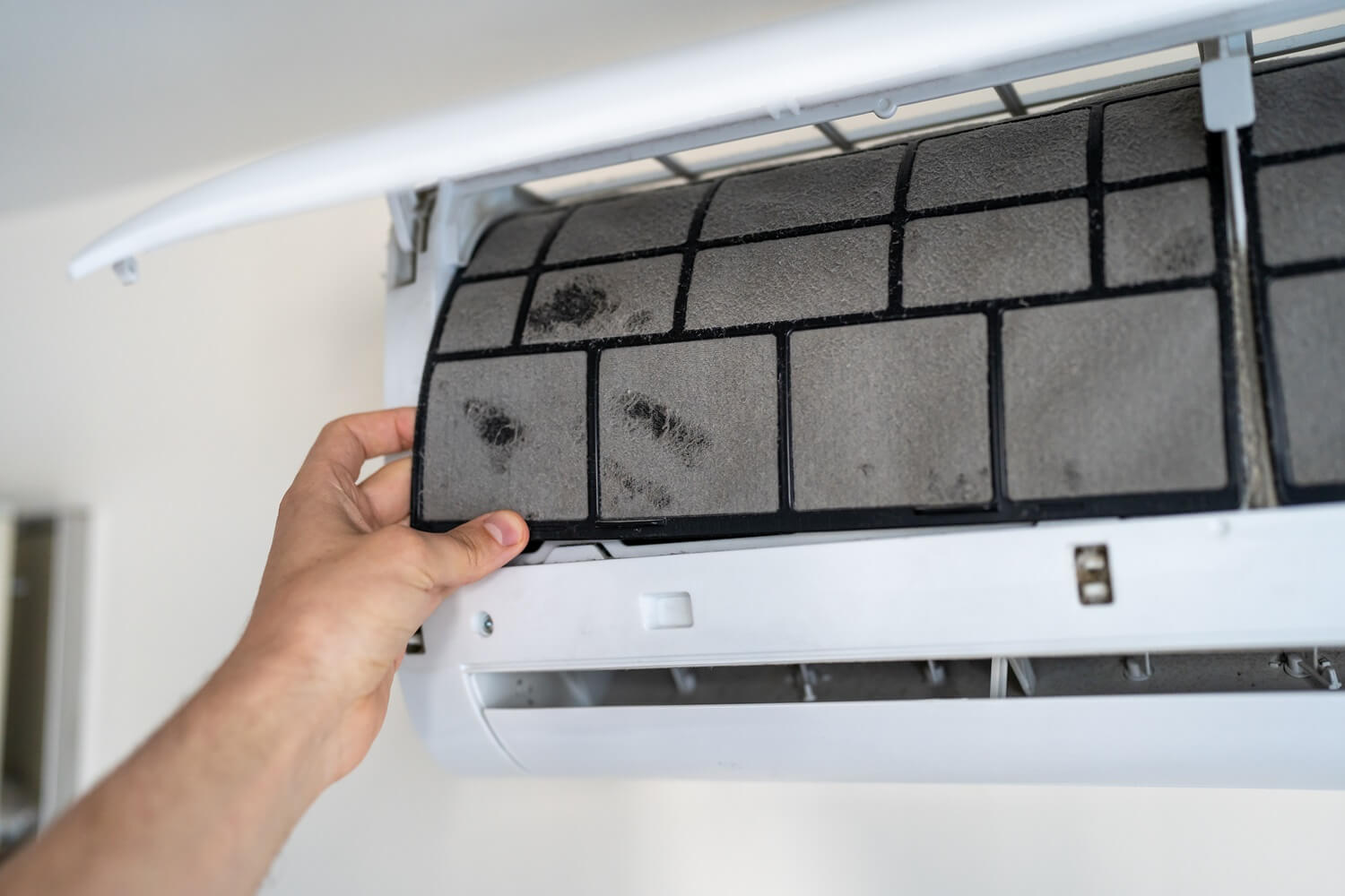 hvac technician cleaning mold in an AC Unit